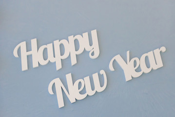 Fototapeta na wymiar White inscription happy new year on a blue background