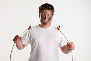 Man holds wires on white background