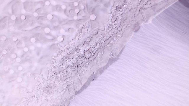 Pale pink lavender color paint flow abstract background footage. Contemporary fluid art animation. Acrylic and oil paints popping bubbles effect motion. Watercolor spreading close up