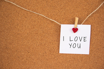 i love you red heart note on cork board