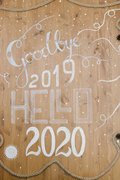 Christmas Decor, Inscription Goodbye 2019 Hello 2020 On A Wooden Background