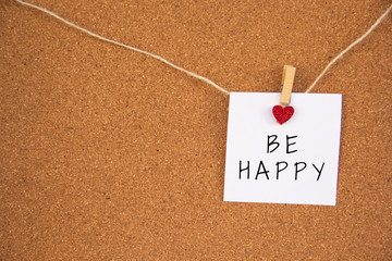 be happy red heart note on cork board