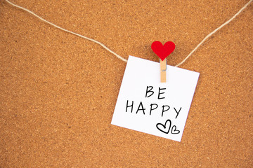 be happy red heart note on cork board