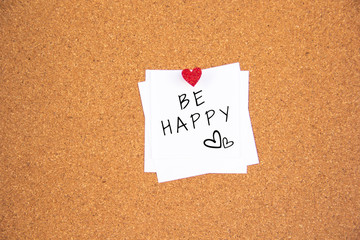 be happy red heart note on cork board