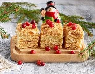pieces of baked layer of cake Napoleon with butter cream