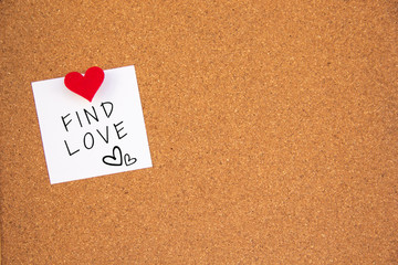 red heart find love note paper on cork board