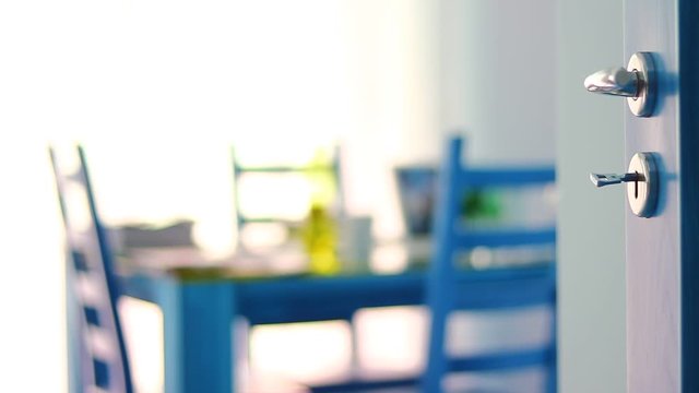 Doors opened to an apartment with table, dish, plastic containers, bottles, food on it. Artistic presentation.