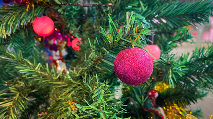 Obraz na płótnie Canvas Red ball hanging on the Christmas tree. Decorate Christmas tree.