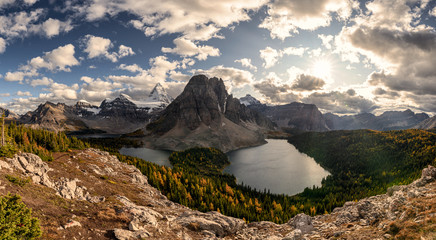 Mount Assiniboine with Sunburst and Cerulean lake in autumn pine forest at British Columbia