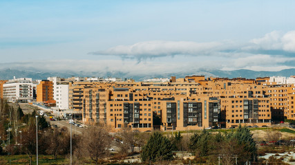 View of residential neighbourhood in Las Tablas, Madrid, Spain with mountain range in background