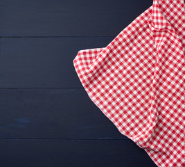 white red checkered kitchen towel on a blue wooden background