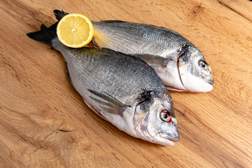 Fresh raw dorado fish with spices. Ingredients for cooking or grill on cutting board. Top view, copy space