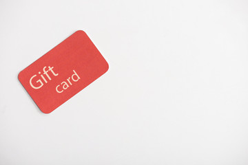 Top view of gift card on white surface with copy space