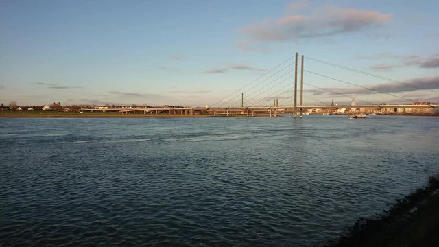 Timelapse of big river and moving ships with dark clouds in the sky
