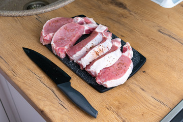 Pieces of different fresh meat on kitchen table