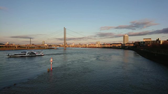 Timelapse of ferryboat maneuver on the river with moving clouds in the sky