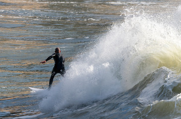 a surfer surf a wave in italy