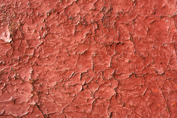 Cracked red paint with rust. Seamless old texture background