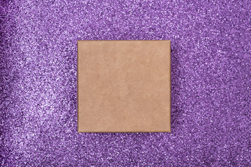 Fototapeta premium Square craft box on a shiny lilac surface. Directly above