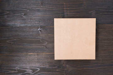 Square craft box on a brown wooden table. Directly above