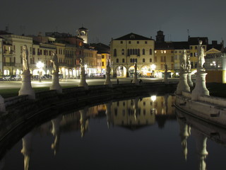 Padova, Italy - October 12th, 2019: Prato della Valle, in Padova, at night. The biggest square in Italy and one of the biggest in Europe, surrounded by a canal of water and by two rings of statues.
