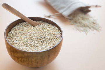 Raw quinoa close up in a wooden bowl