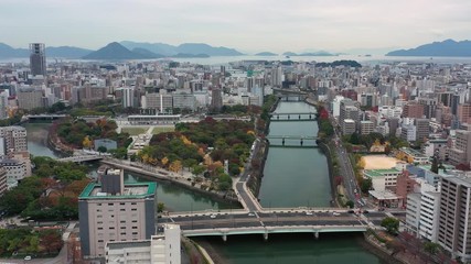 Aerial view of Peace Memorial Park and Atomic Bomb Dome (Hiroshima Peace Memorial) in city of Hiroshima, autumn scenery with colorful trees - landscape panorama of Japan from above, Asia