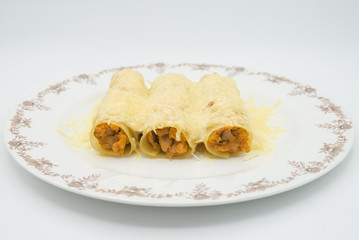 meat filled pasta on a plate. Italian cannelloni, Spanish canelones.