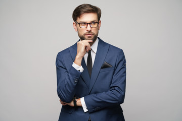 Studuo shot of thinking businessman wearing suit