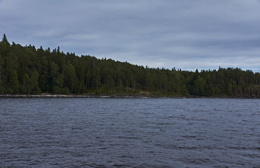 The nature of Karelia.Typical Karelian landscape on the island of Valaam: forest of conifers, Lake Ladoga, crag and volcanic rocks. Russia, Karelia