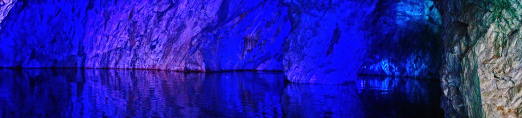 Underground Grotto Panorama.Types of a former underground marble quarry flooded with water. The...