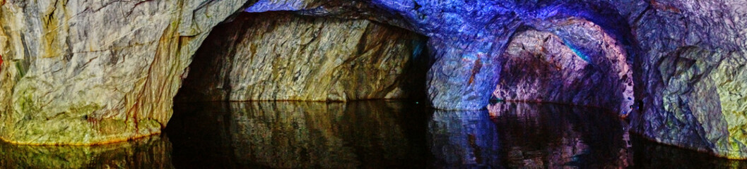 Underground Grotto Panorama.Types of a former underground marble quarry flooded with water. The massive arches of the grotto and the texture of natural marble are visible. Russia, Karelia, Ruskeala