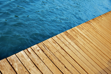wooden pier with lake water