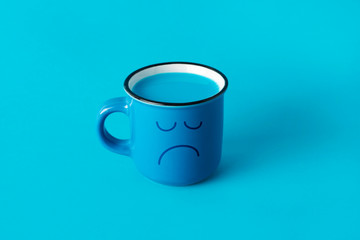 blue mug with a sad face