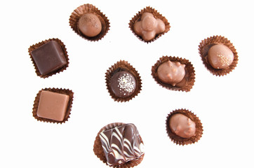 chocolate candies in a candy wrapper on a white background. A set of sweets with different tastes ..