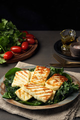Cyprus fried halloumi cheese with healthy green salad. Lchf, pegan, fodmap, paleo, scd, keto diet.