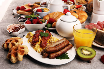 Breakfast served with coffee, orange juice, croissants, cereals and fruits. Balanced diet. Continental breakfast with granola and fruits