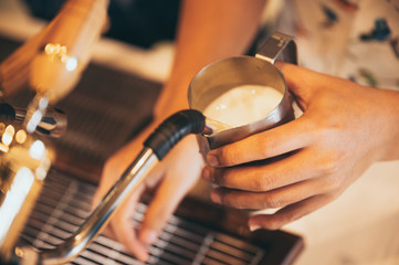 Fototapeta na wymiar Close-up of espresso pouring from coffee machine. Professional coffee brewing