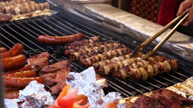 Fresh grilled sausages and barbecue steamed in an outdoor cafe at the fair