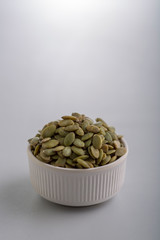 Dry pumpkin seeds in a small cup