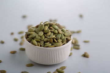 Dry pumpkin seeds in a small cup