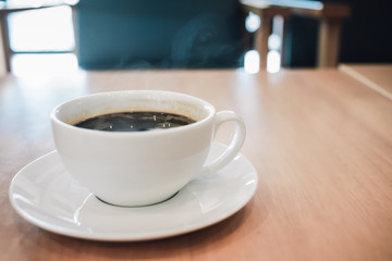 aroma coffee cup with smoke on wooden table in the morning.
