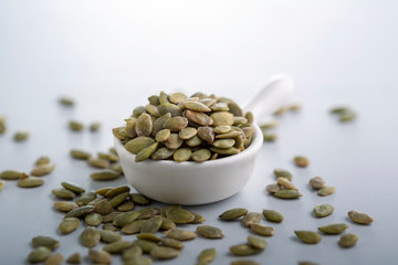 Dry pumpkin seeds in a small cup