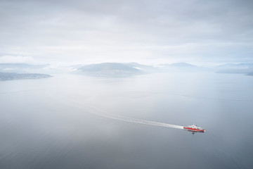 Ferry ship crossing on open vast ocean cruise journey aerial view from above during atmospheric...