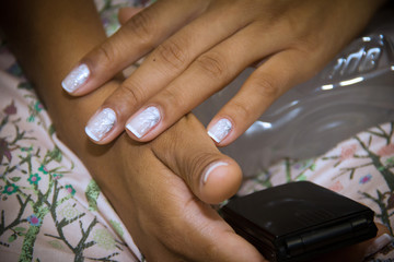  Closeup of bride's hands with nails done just before the wedding ceremony.