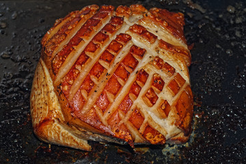 Directly above of ready roast pork with crackling