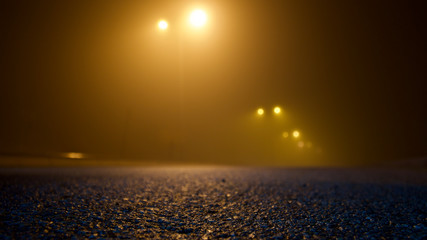 empty road and lighting poles on a foggy night