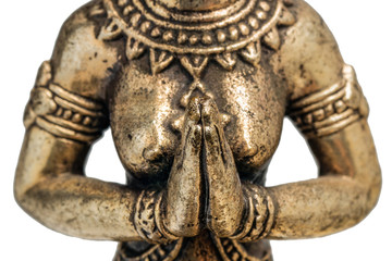 Eastern deity goddess fairy or angel praying with folded hands in front of his chest. bronze gold figurine close up