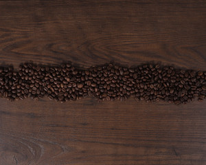 Coffee beans on brown wood background