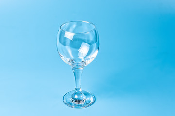 Empty wine glass on blue background	
